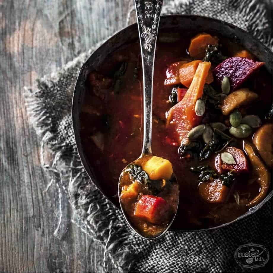 Healthy Detox Vegetable Soup with a spoonful resting across the bowl.