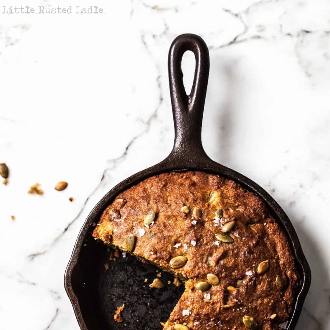 cast iron pumpkin bread on bright marble surface