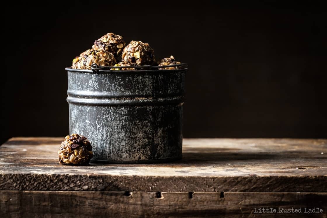 Metal bucket filled with little granola balls.