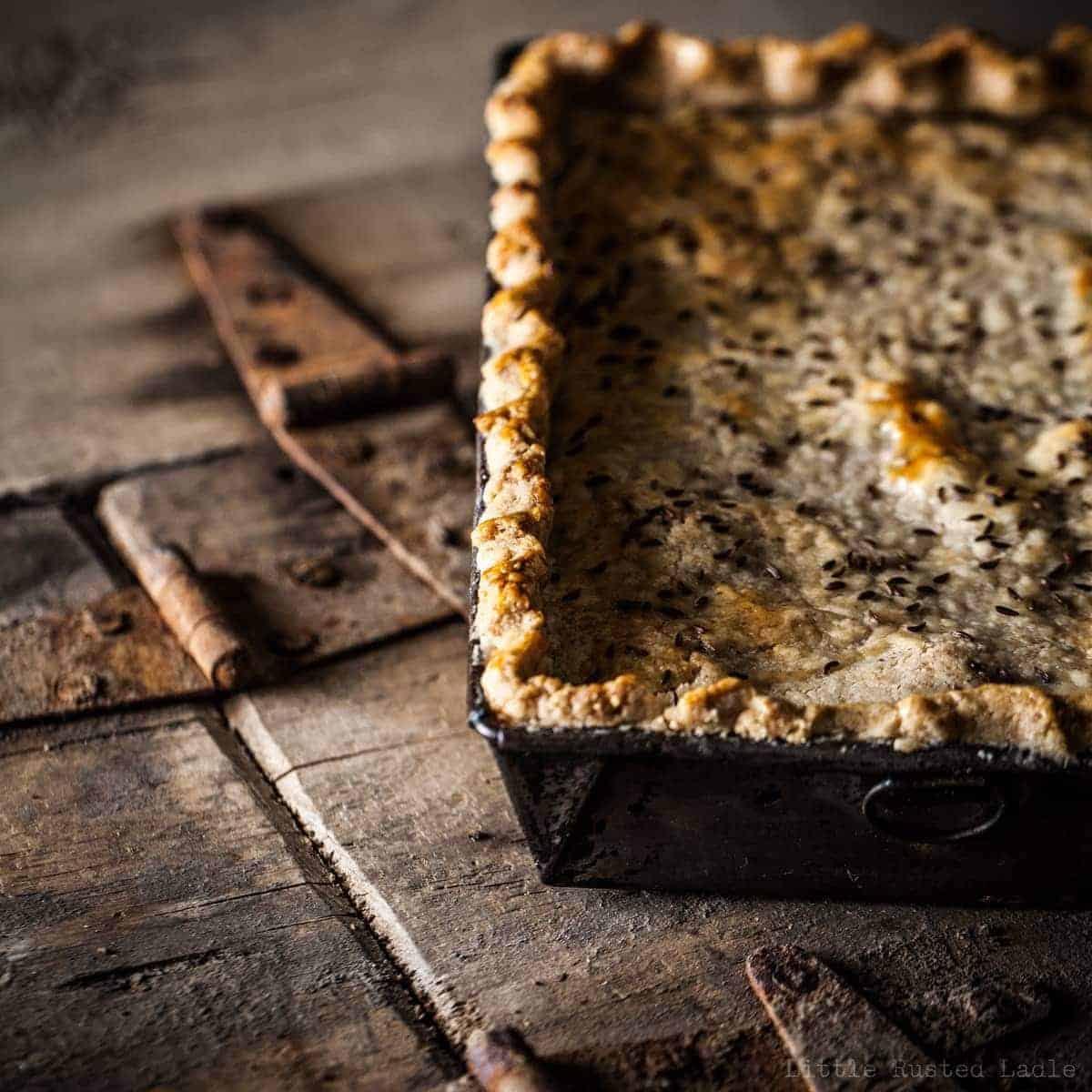 Off center rectangle pot pie on rustic background