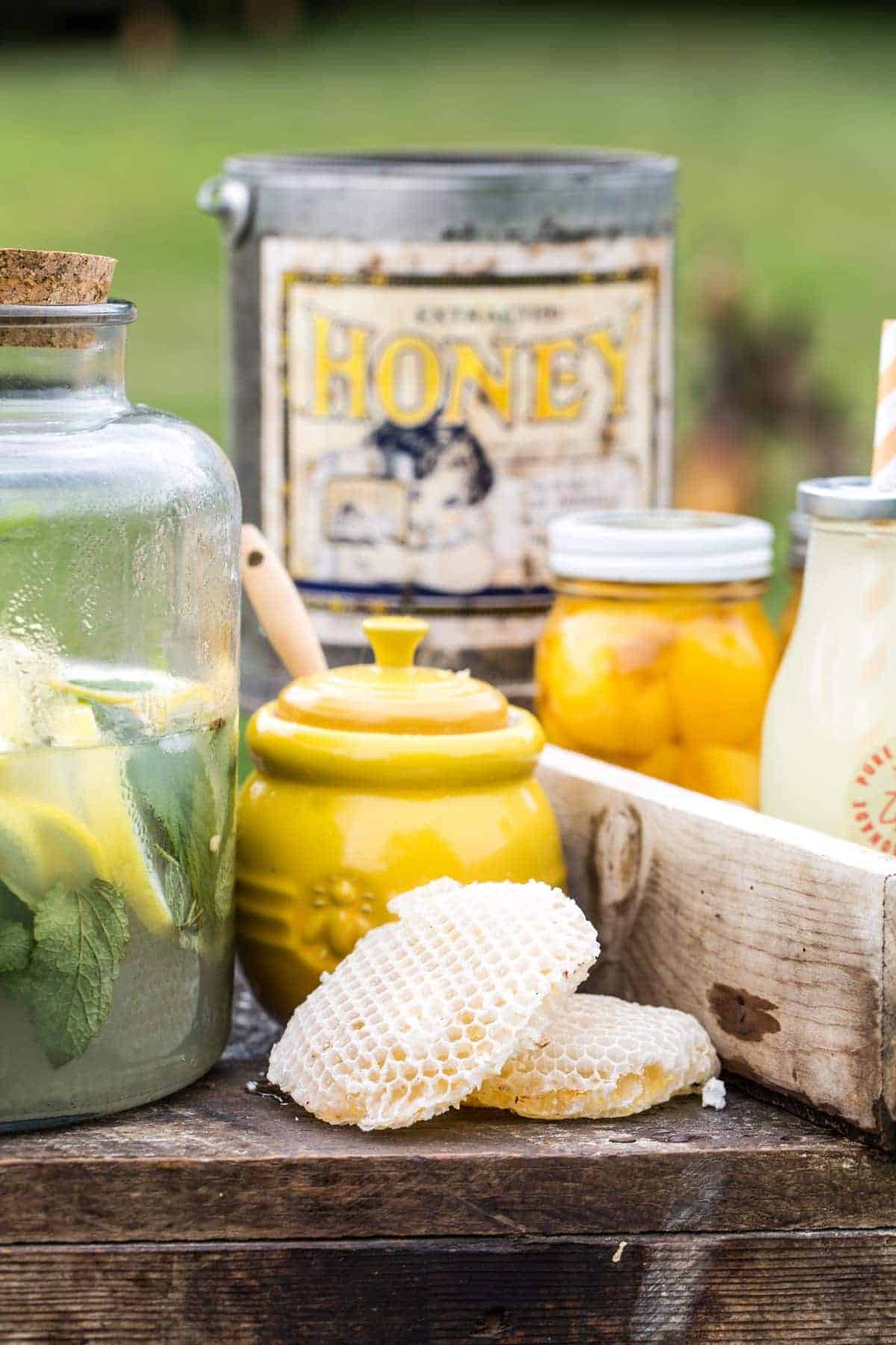 honey pot and honey comb on the rustic stand.