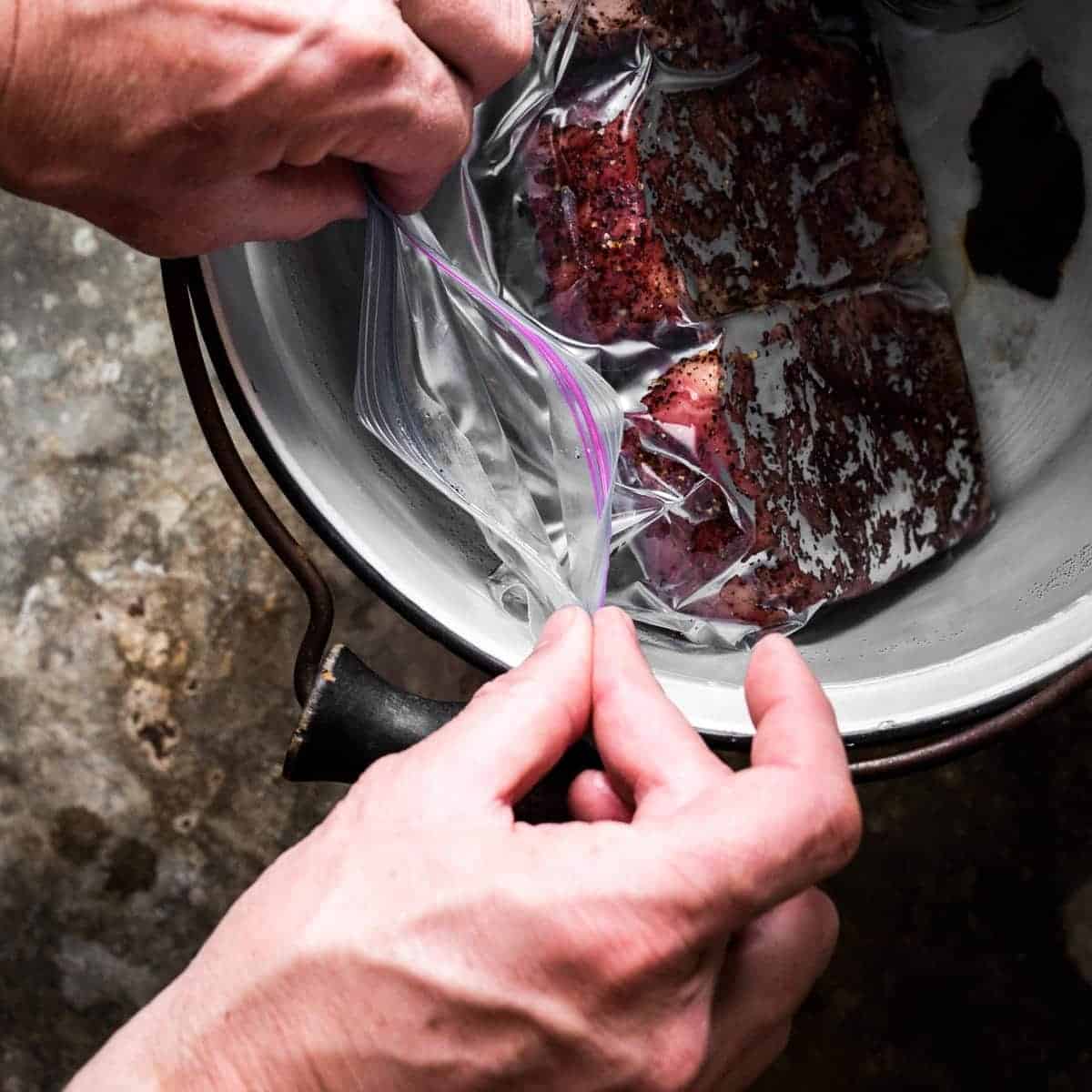 Process shot of removing the air from the resealable bag by submerging it partly in water.