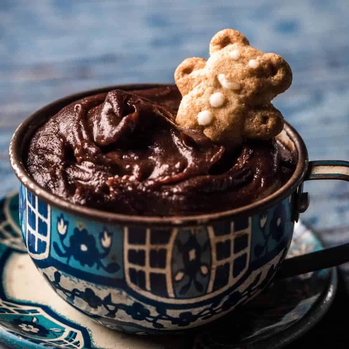 Teacup of chocolate dessert hummus with teddy bear cookies for dipping