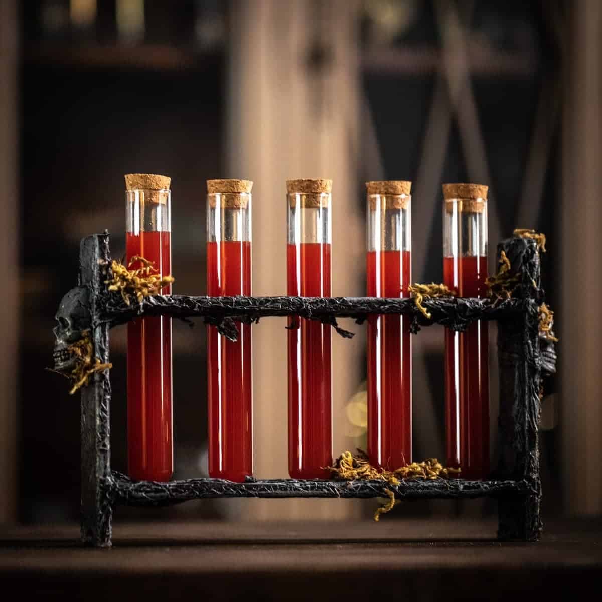 Side view of five test tubes in the vintage DIY Halloween Shots holder