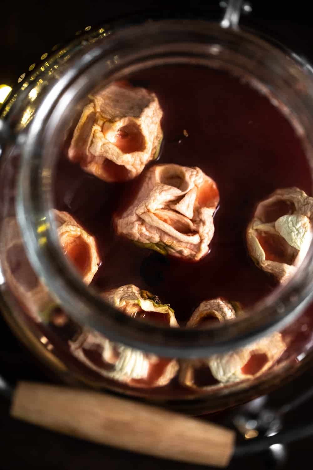 Carved apple skulls in pitcher of Old Fashioned