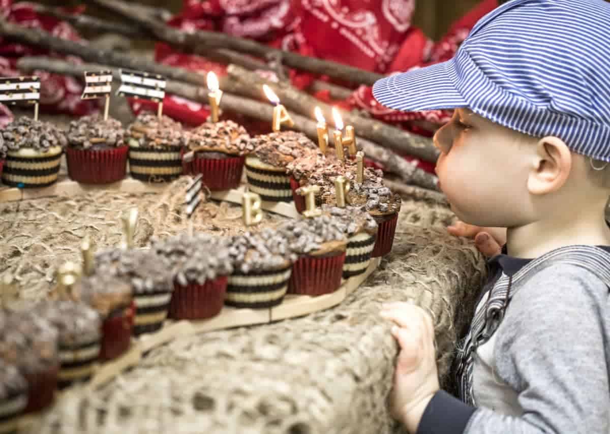 Austin blowing out the candles on his cupcake train