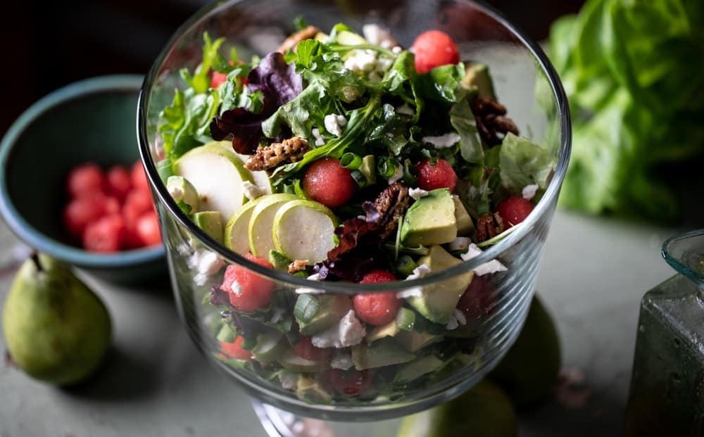 Salad from above in glass serving bowl. 