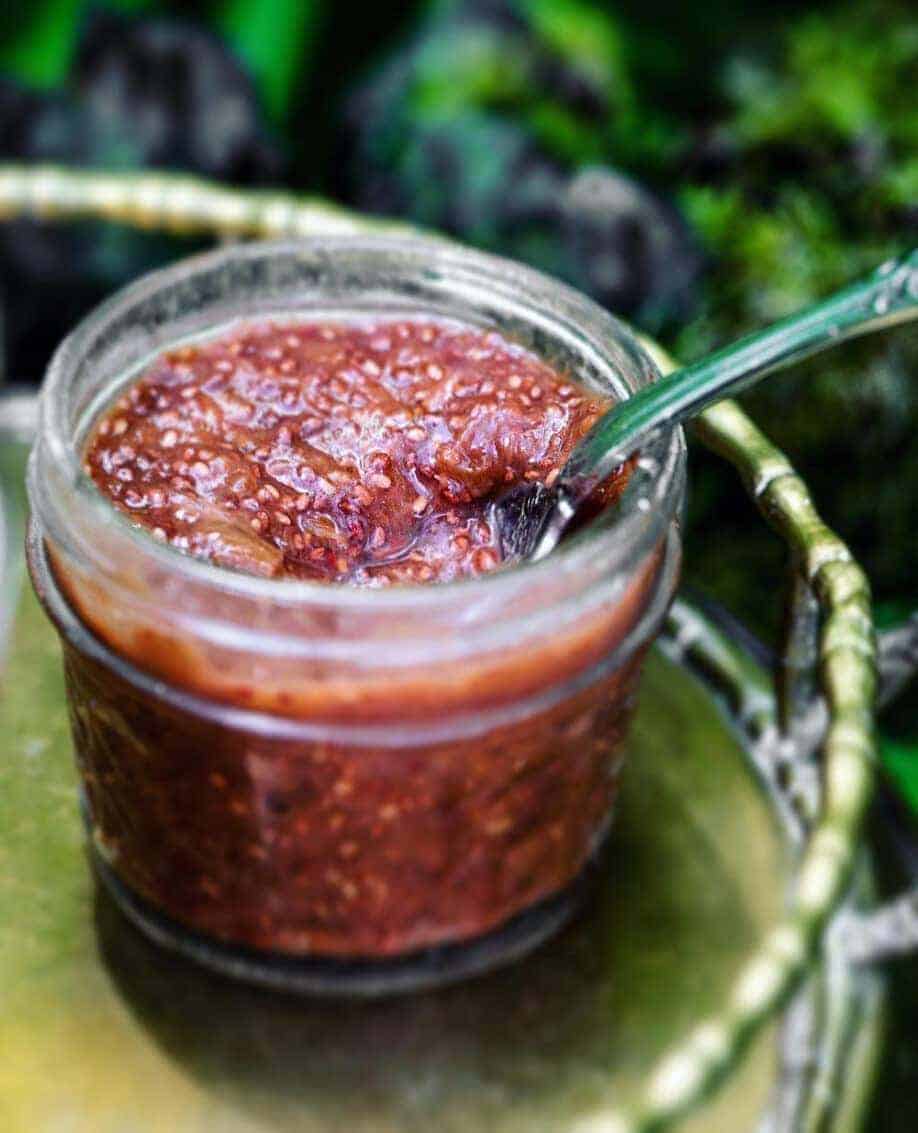 Closeup of jam in glass jar with a vintage spoon. 