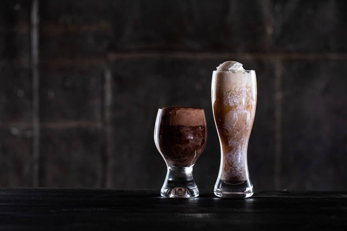 Two fun glasses with beer floats in them. Showing how lighting of first glass blocks the second. 