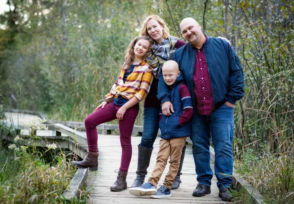 Family photo outdoors in the fall apple picking