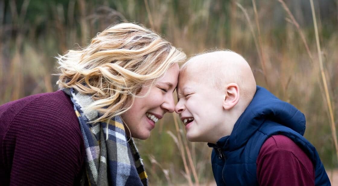 emotional mom and son laughing together