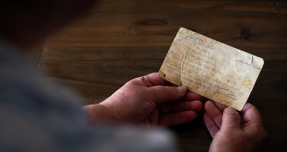 Grandma holding aged recipe card