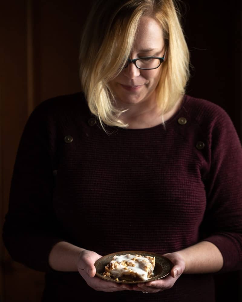 Woman holding dessert with moody lighting