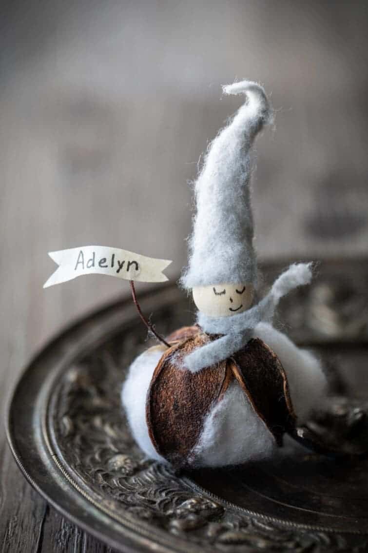 Place card with the base made from a cotton blossom with a wood bead head with gray felt hat. Handmade Gift