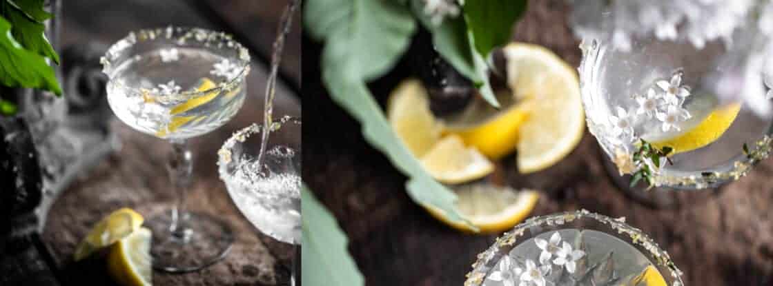 wide Pour shot drink photography lemon drop martini in rustic setting with thyme lemon zest and lilac on the rim of the class recipe