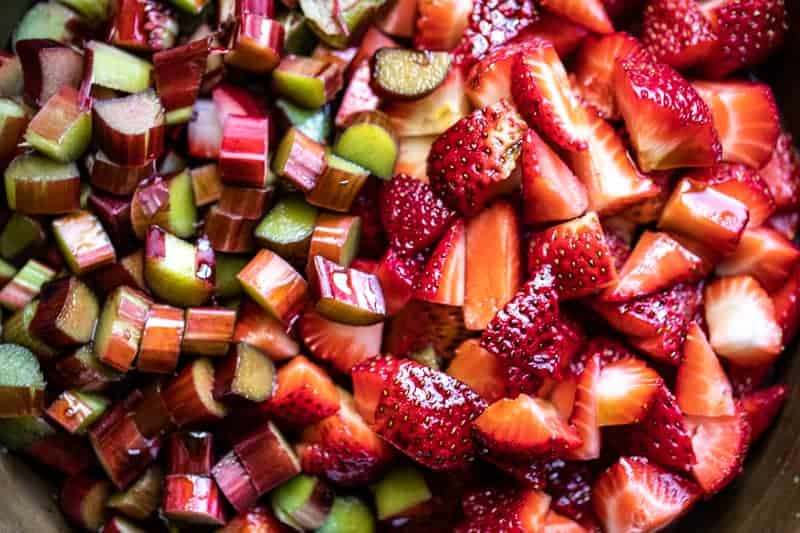 Closeup of chopped strawberries and rhubarb in a saucepan. 