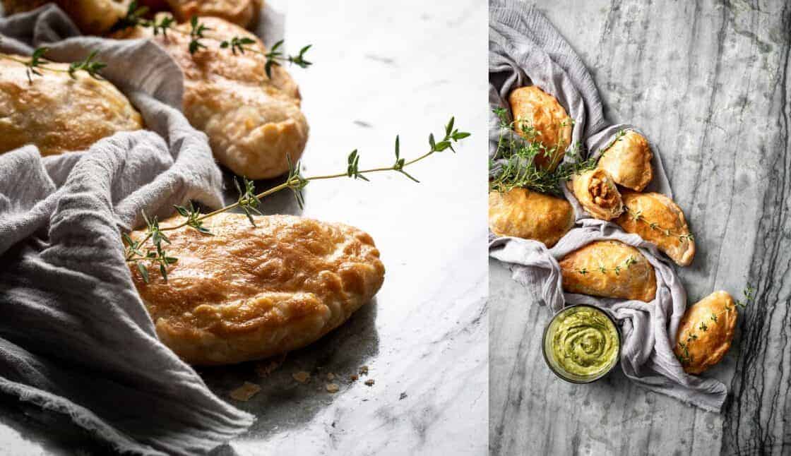 overhead photo of golden brown hand pies on a gray marble surface