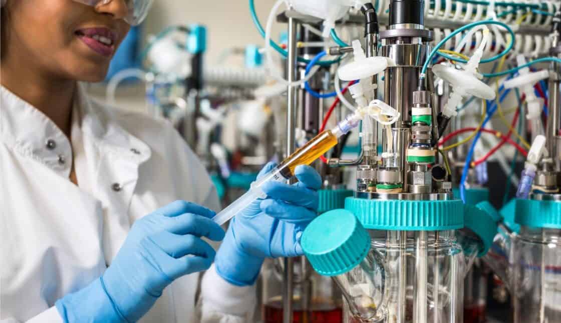 scientist in a medical lab with a syringe