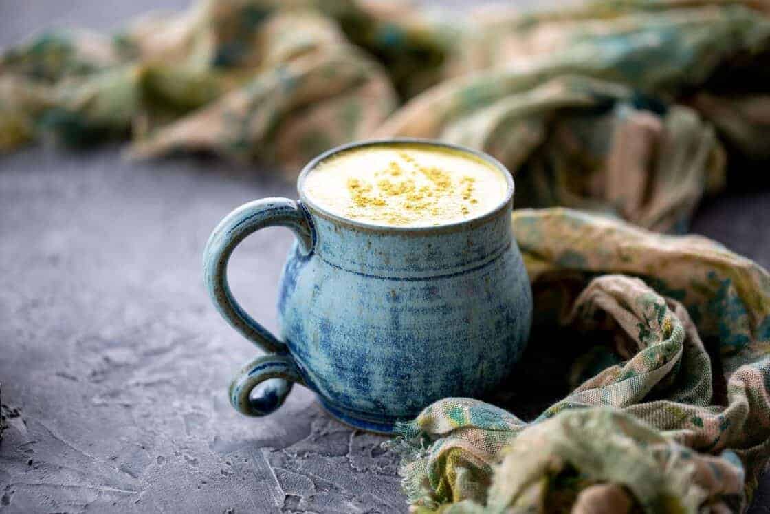 blue mug with hot tea beverage with spice on top