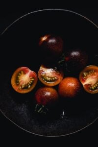halved cherry tomatoes in a moody setting