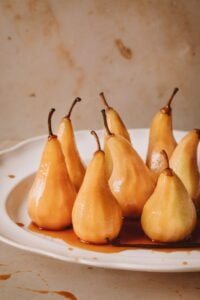 Baked peaches on a plate with caramel sauce