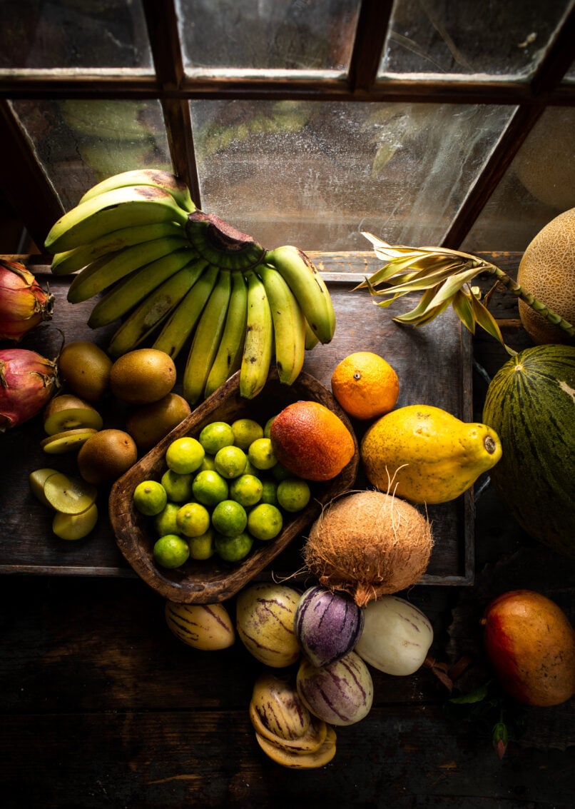 Overhead shot of tropical fruits by window food photography.