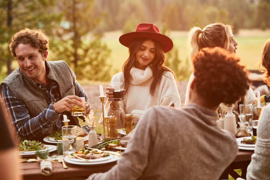Lifestyle food photographer adult outdoor dinner party at golden hour