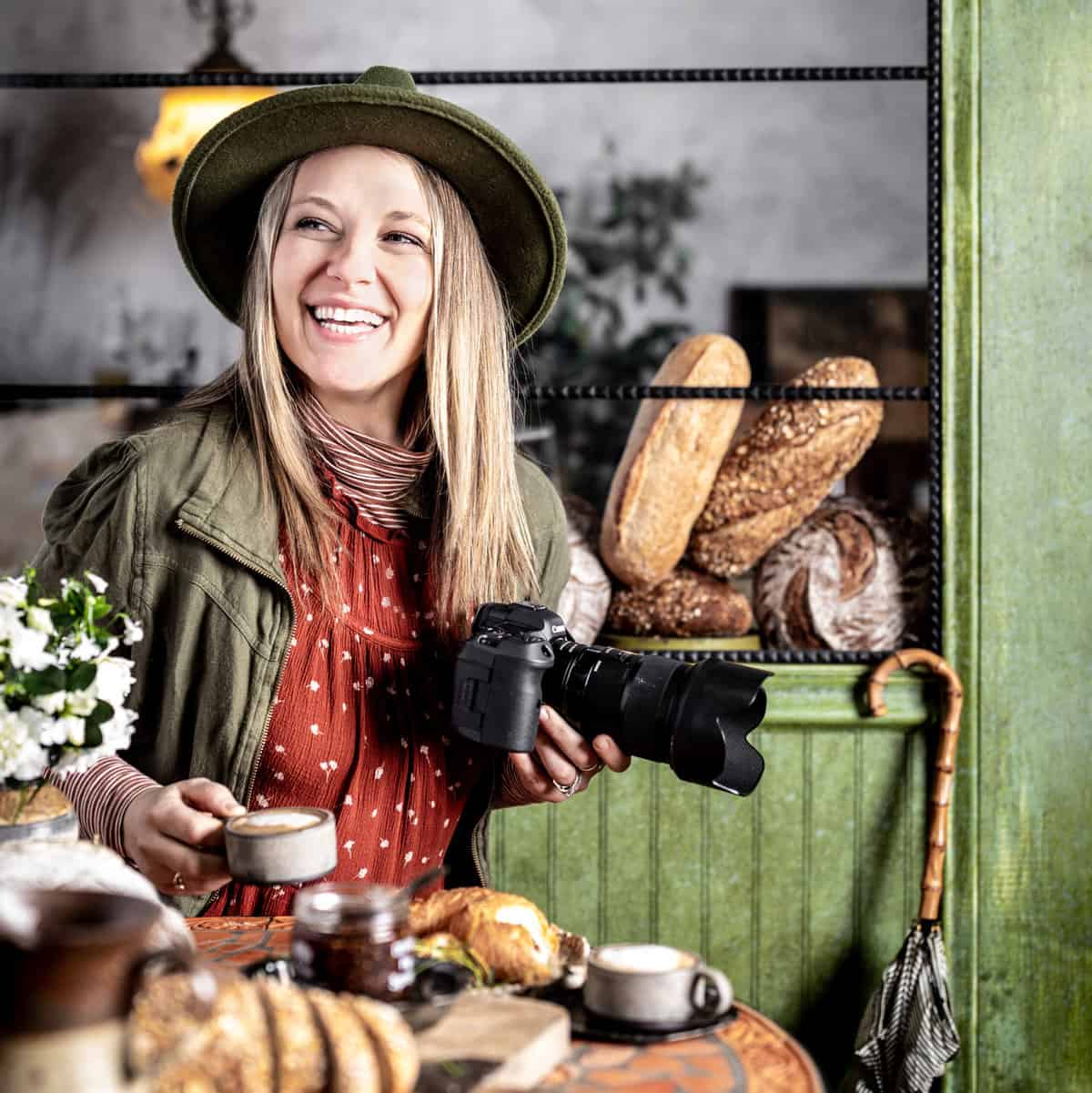 food photographer posing at cafe window with camera