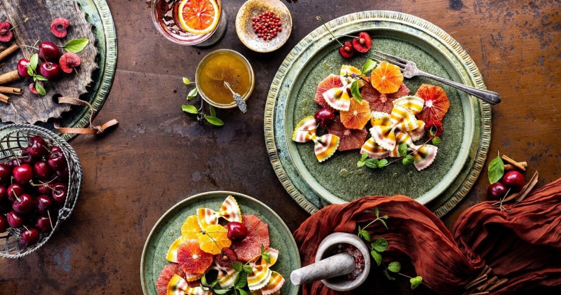 Overhead image of citrus salad with rusted metal food background