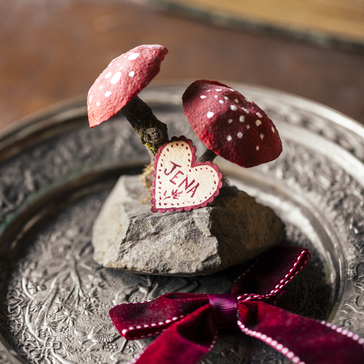 DIY red polka dot mushroom decor place card holder craft idea. 3/4 view close up detal shot. dark and moody